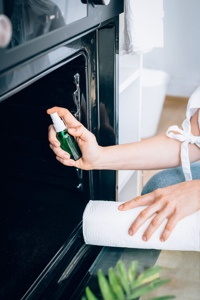 Finish oven cleaning by spraying it down with white vinegar