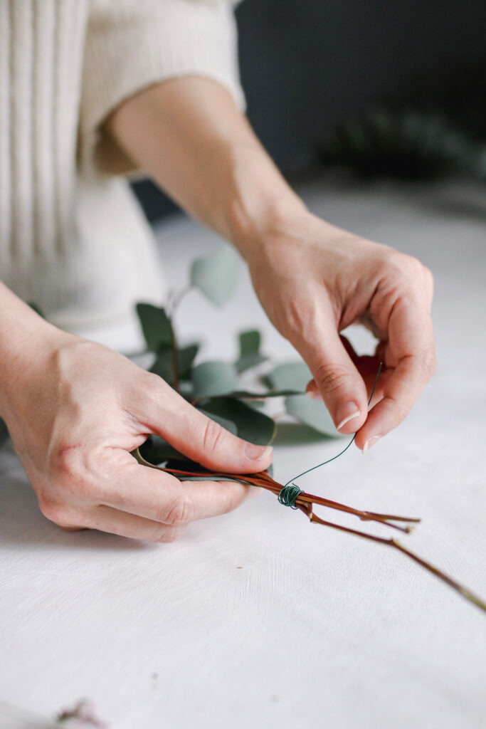 Wiring eucalyptus together for wreath