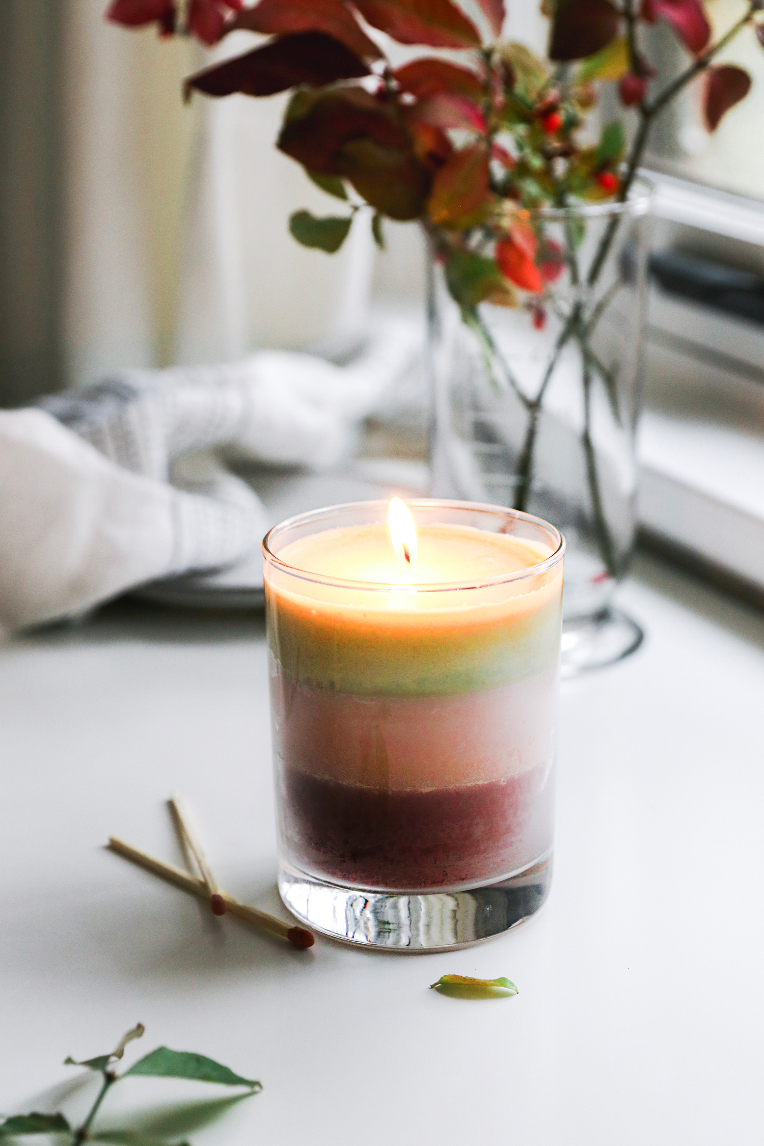 Just a few simple ingredients make up these cute, gift-worthy DIY holiday candles, layered with holiday colors and scents.