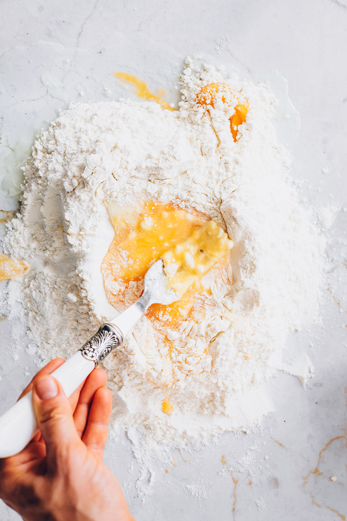 Mixing flour and eggs for homemade pasta