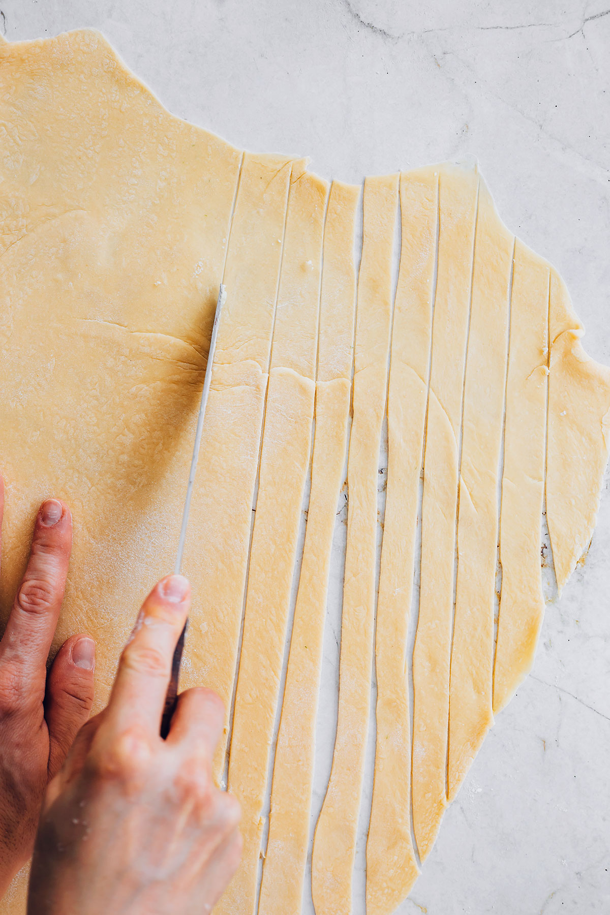 Cutting homemade pasta strips