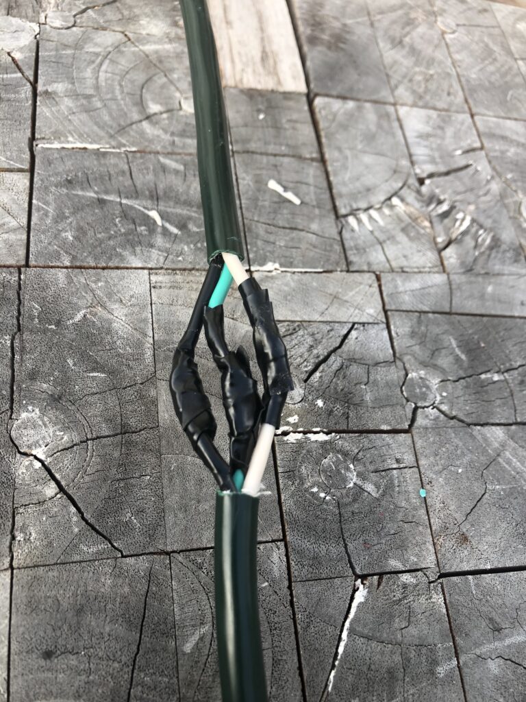 Taping wires together to fix a cut extension cord