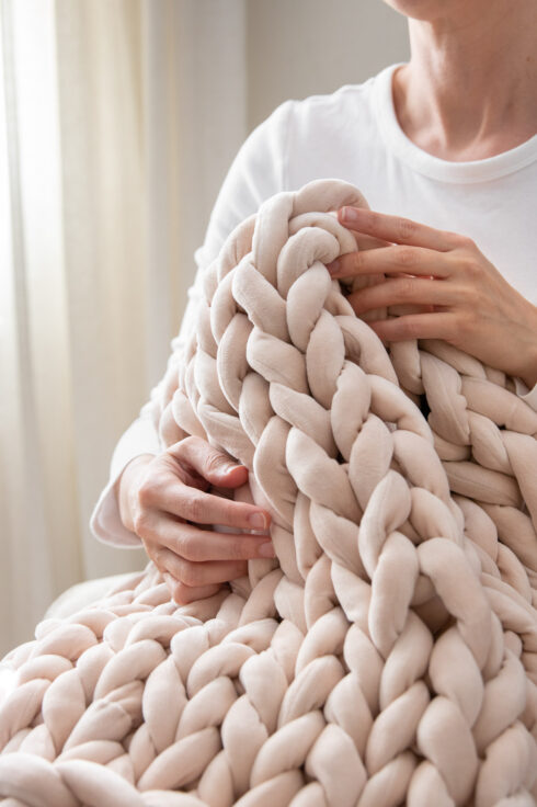 Make Your Own Inexpensive, Hygge Arm Knit Blanket | Hello Nest